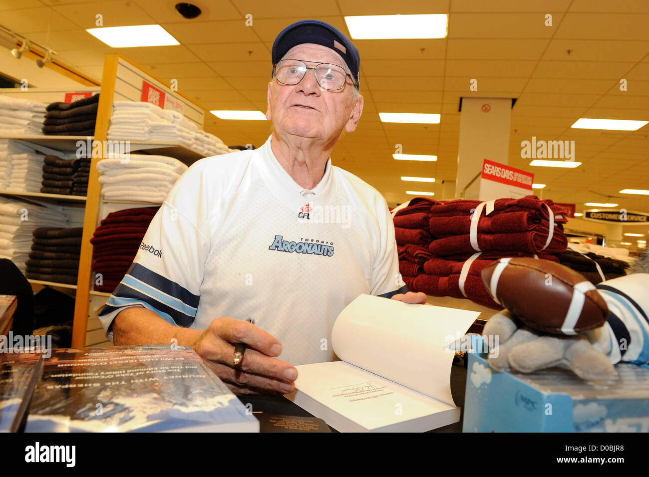 November 21, 2012. Toronto, Canada. CFL Argonauts Legend Zeke O'Connor  signs copies of his new book: Journey with the Sherpas at the Sears department store in Fairview Mall. (DCP/N8N) Stock Photo