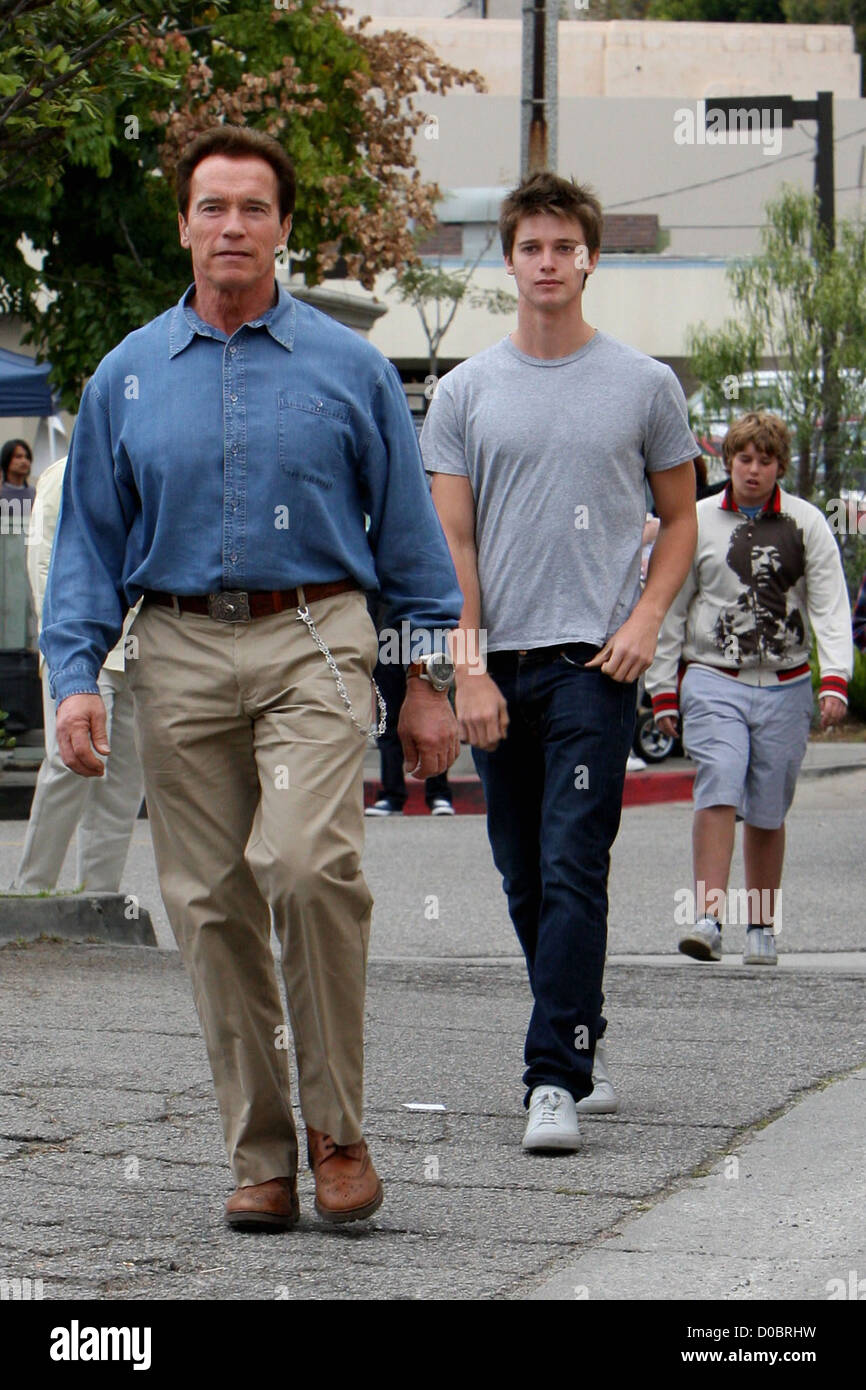Arnold Schwarzenegger takes his sons to a pop-up animal adoption centre