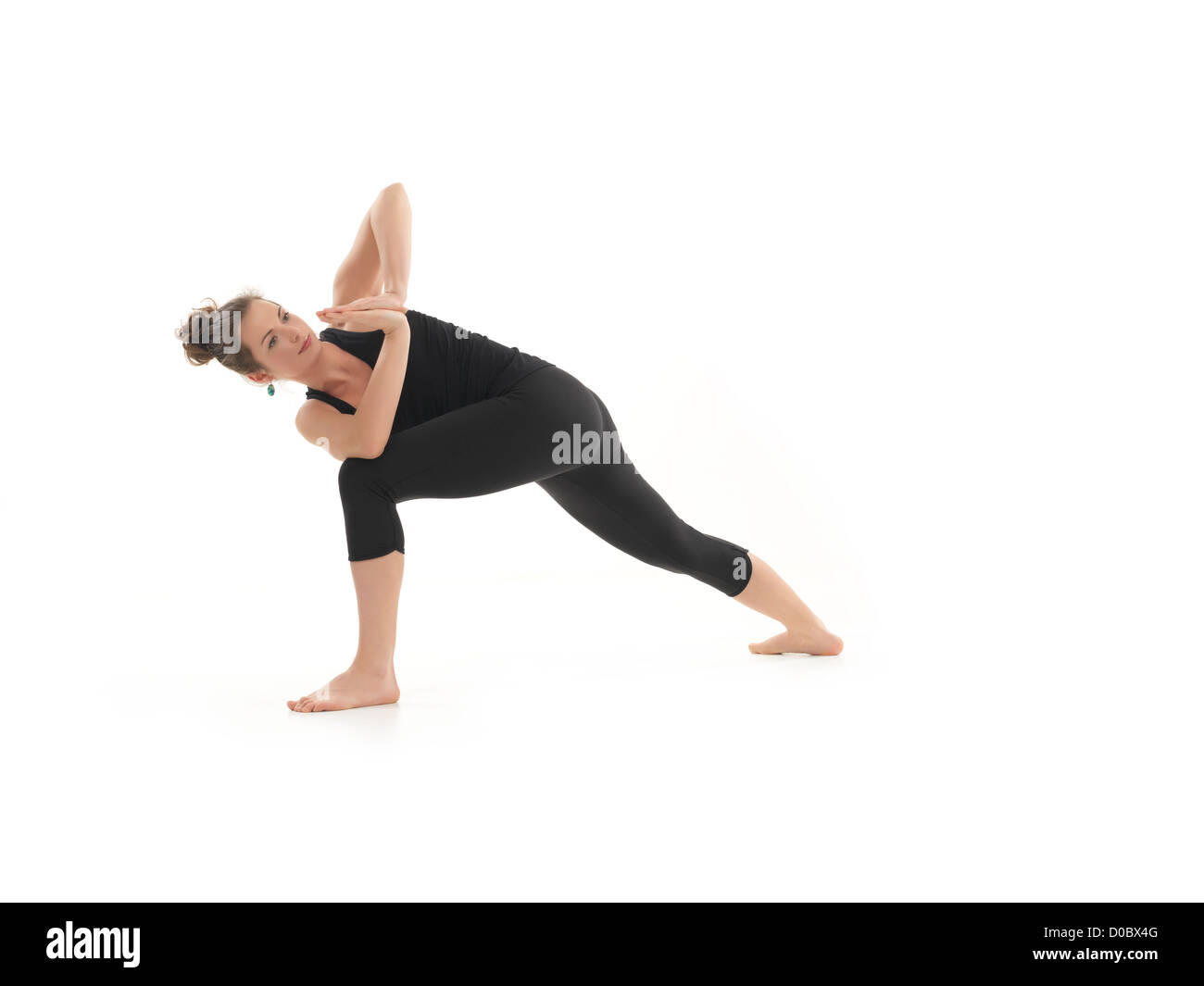 variation of yoga posture demonstrated by young blonde female, dressed in black, on white background Stock Photo