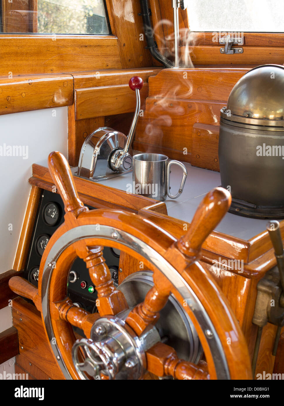 The polished wooden wheel of a 1950s wooden hulled diesel driven 4 birth leisure boat, Corita