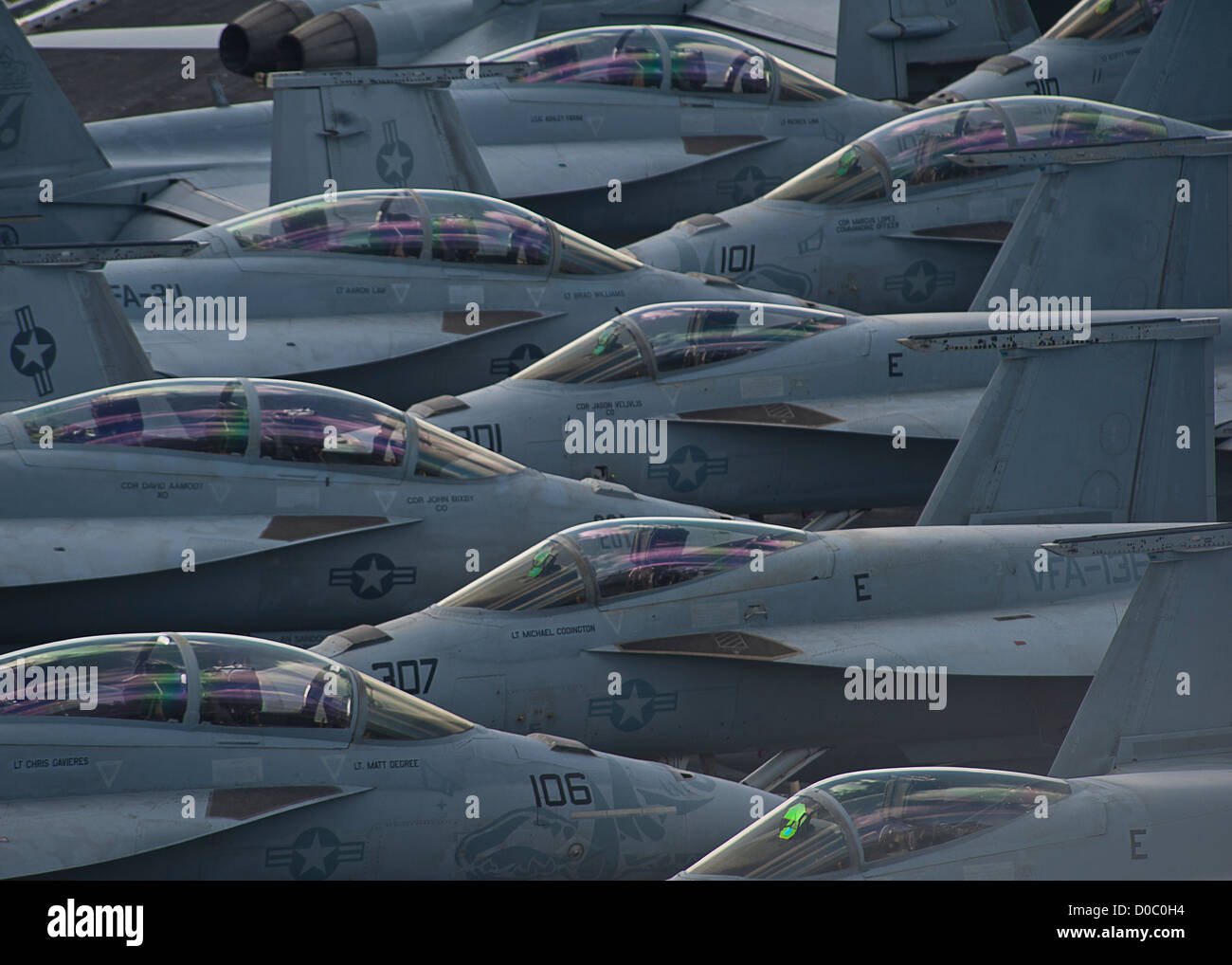 US Navy F/A-18 Super Hornets fighter aircraft sit on the flight deck of the aircraft carrier USS Enterprise October 30, 2012 in the Atlantic Ocean. The Enterprise is the first nuclear powered aircraft carrier and is completing its final scheduled deployment and will be retired on December 1, 2012. Stock Photo
