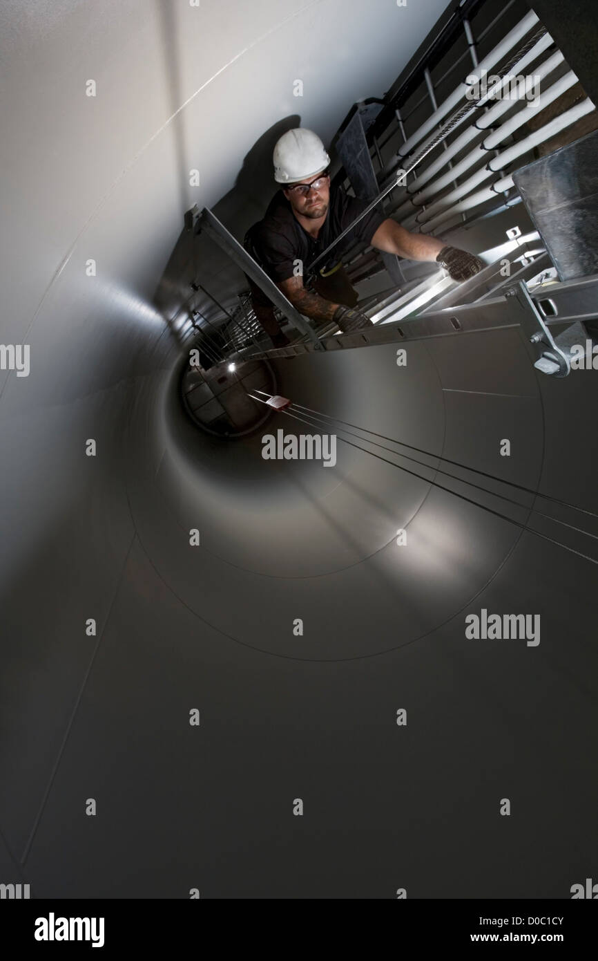 An Engineer Climbs Up the Ladder Inside a Wind Tower Stock Photo Alamy