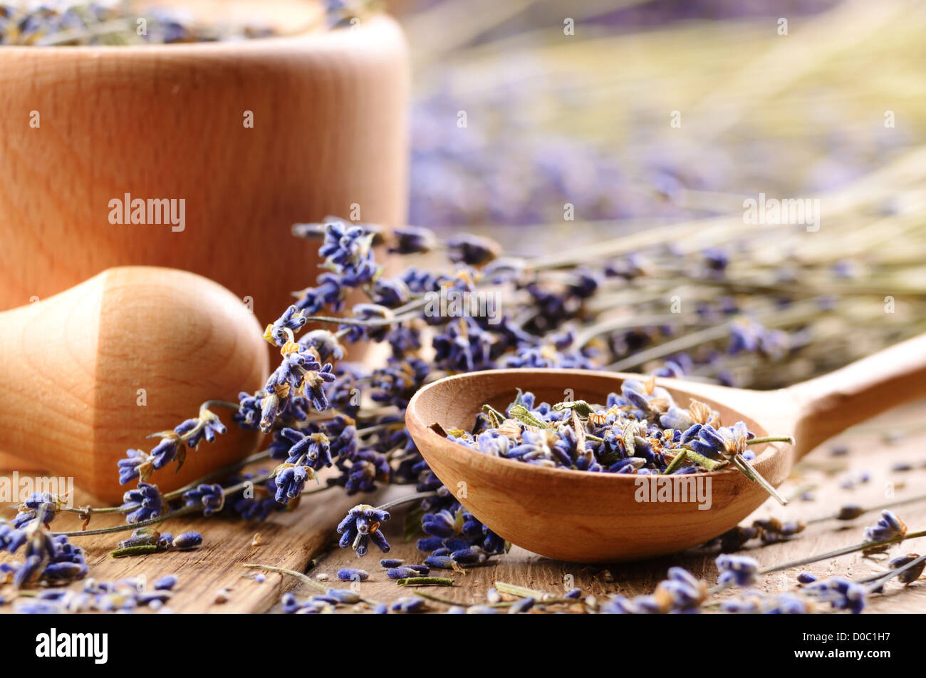 Pestle and mortar with lavender flowers on the oak table Stock Photo