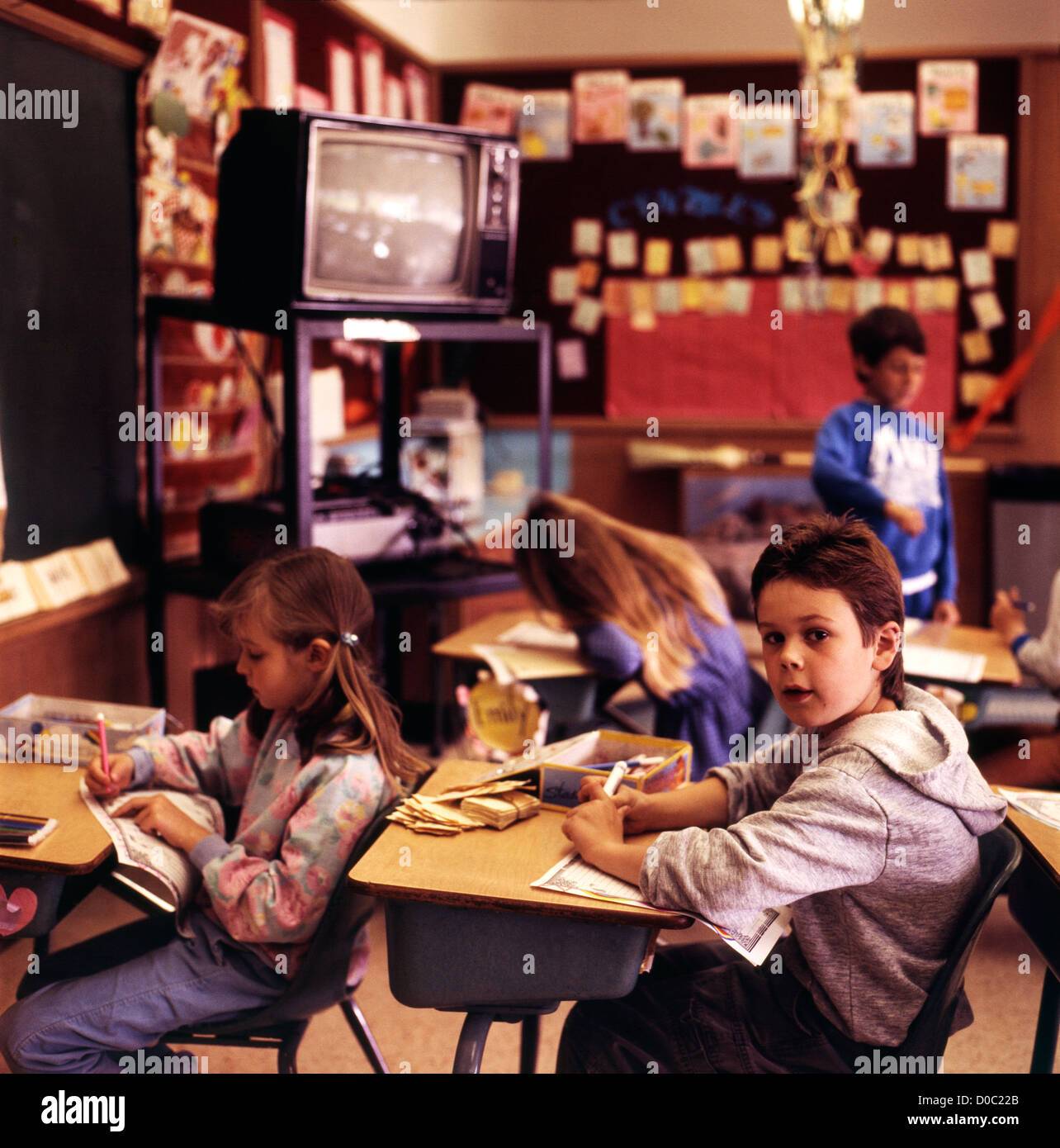 Children sitting at desks in a 1990s primary school classroom in Lantzville on Vancouver Island British Columbia Canada  KATHY DEWITT Stock Photo