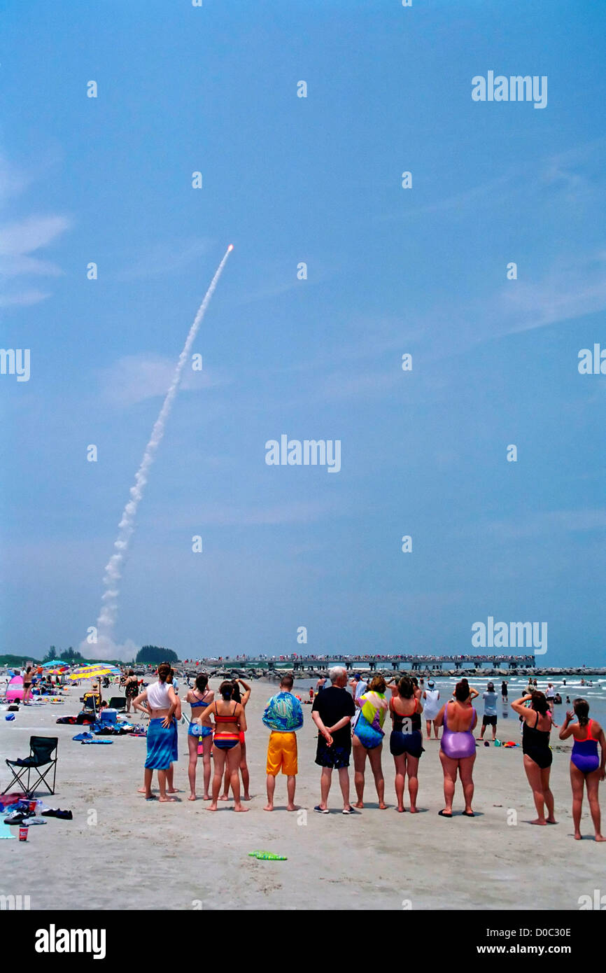 Spectators on beach watch as Delta II rocket launches NASA's Mars Exploration Rover Spirit first twin set landers other being Stock Photo