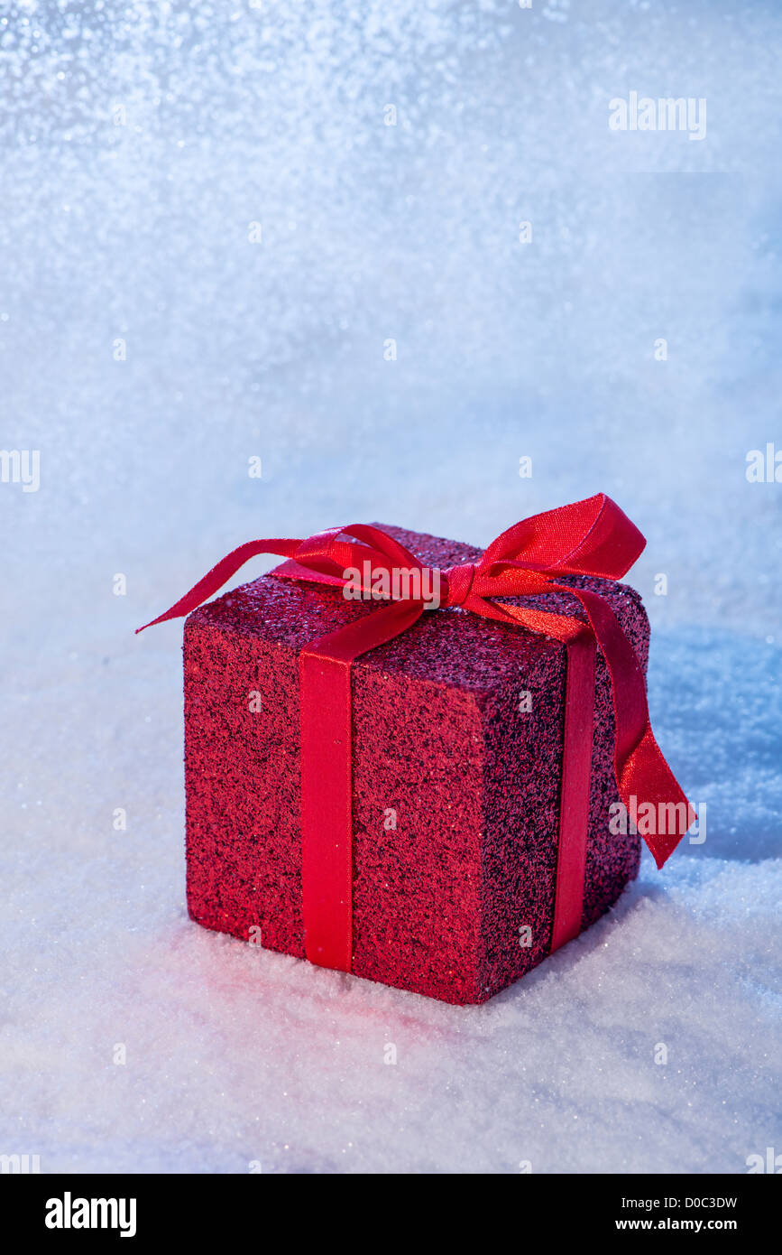 Red Christmas present in snow. Copy space. Stock Photo