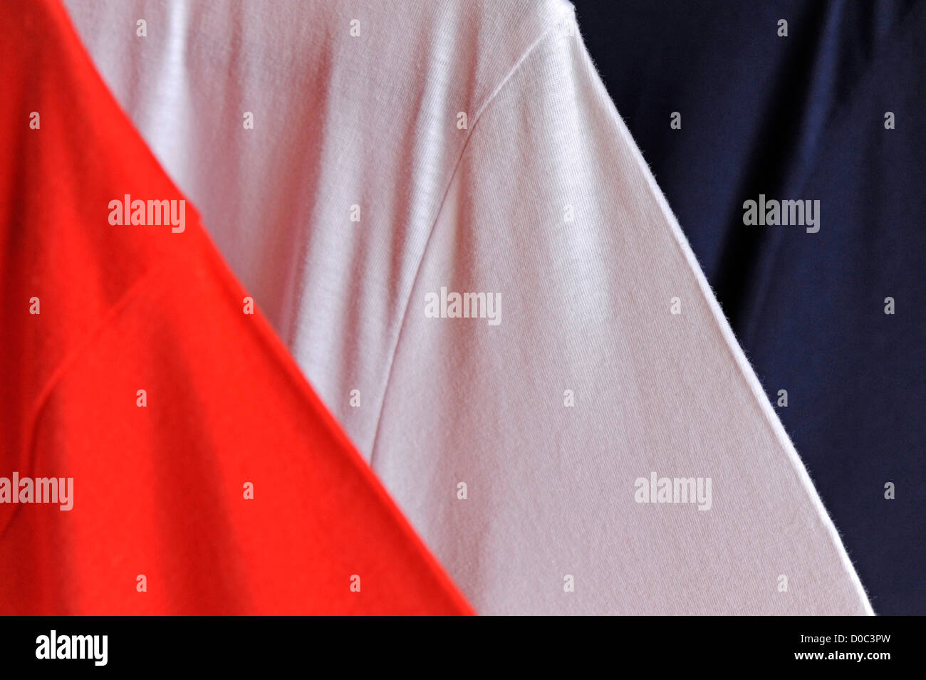 Close-up of three t-shirts (red, white, blue) Stock Photo