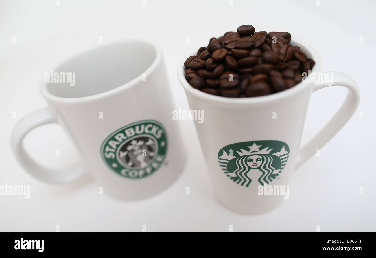 STARBUCKS COFFEE MUGS FILLED WITH ROASTED COFFEE BEANS Stock Photo Alamy