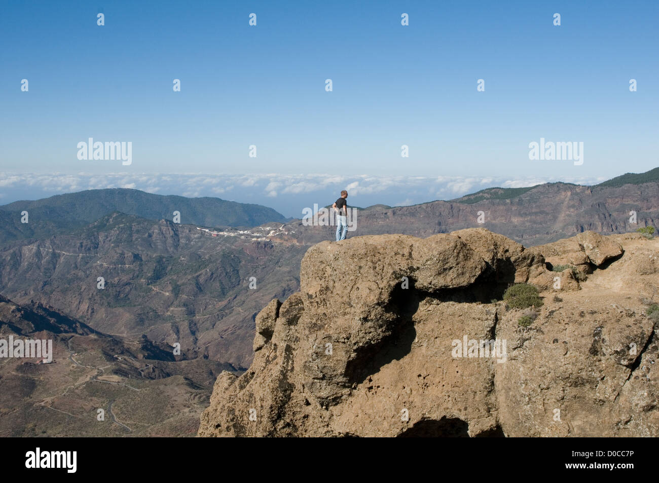 standing on top of the world gran canaria canary islands Roque Nublo man high point life view rocks mountain mountains Stock Photo