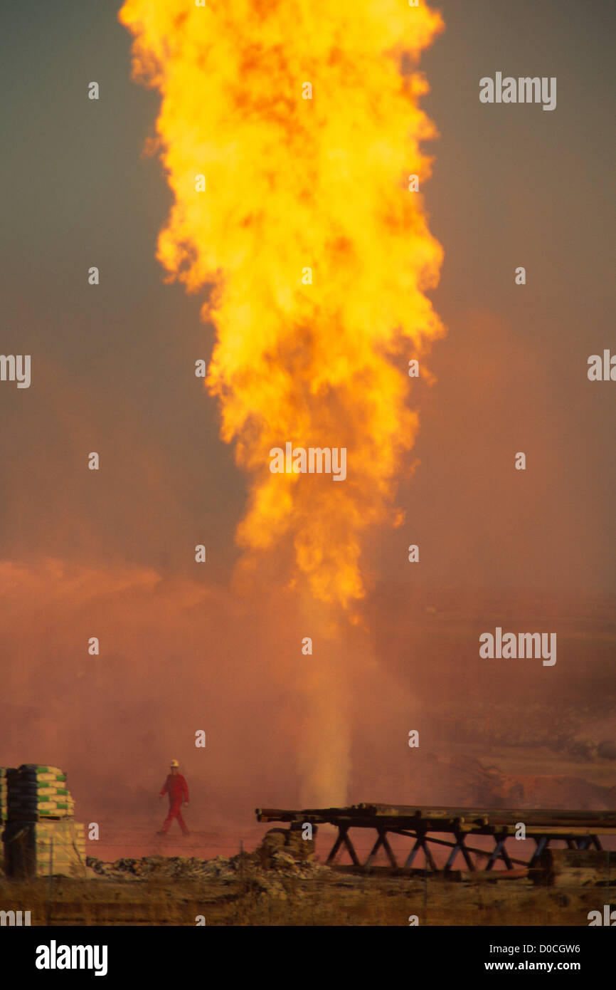 A Natural Gas Well Blowout Dwarfs a Firefighter Stock Photo Alamy