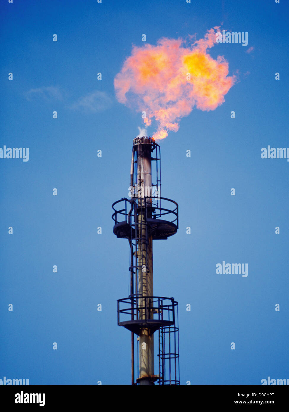 Flaring Tower of an Oil Refinery Reduces Unusable Hydrocarbons to Flame Stock Photo