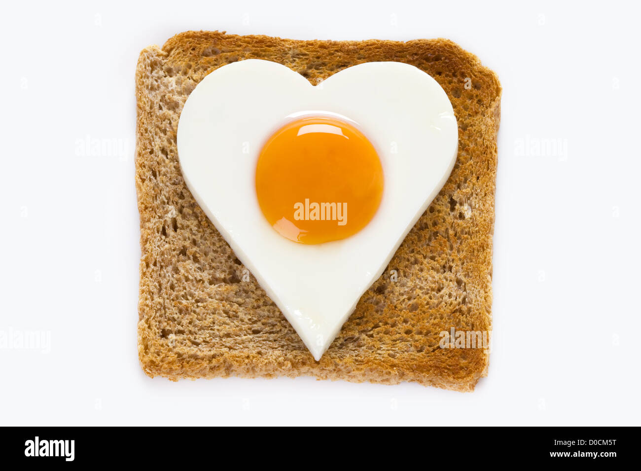heart shaped cooked egg 'sunny side up' on a slice of square shape toast Stock Photo