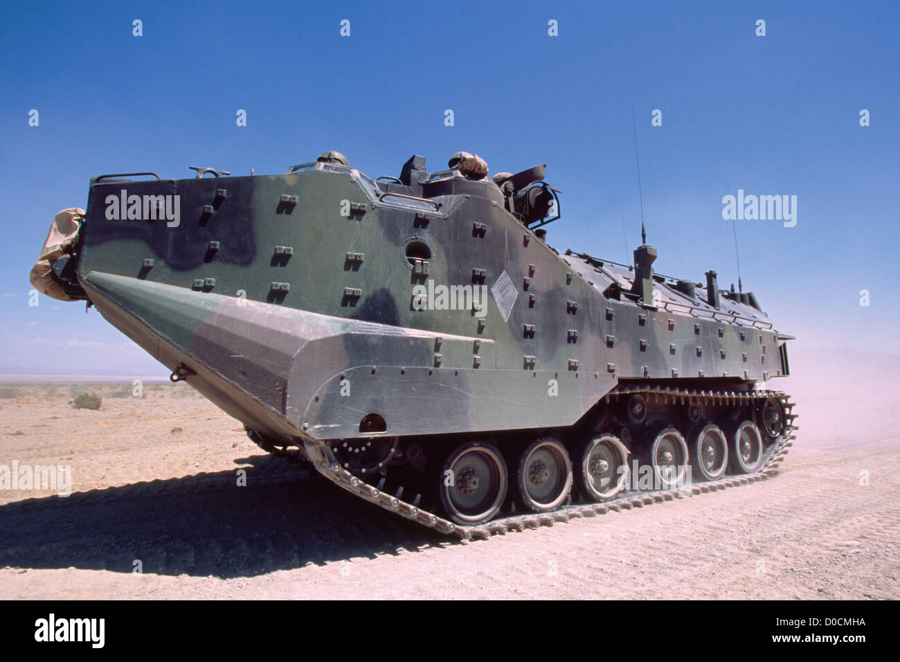 US Marine AAV-7 Armored Personnel Carrier Maneuvers Down a Dirt Road Stock Photo