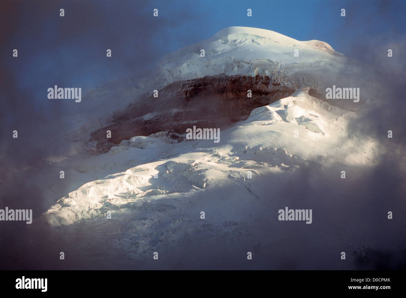Breaking Clouds Reveal Cotopaxi's Jumbled, Heavily Glaciated Summit Stock Photo