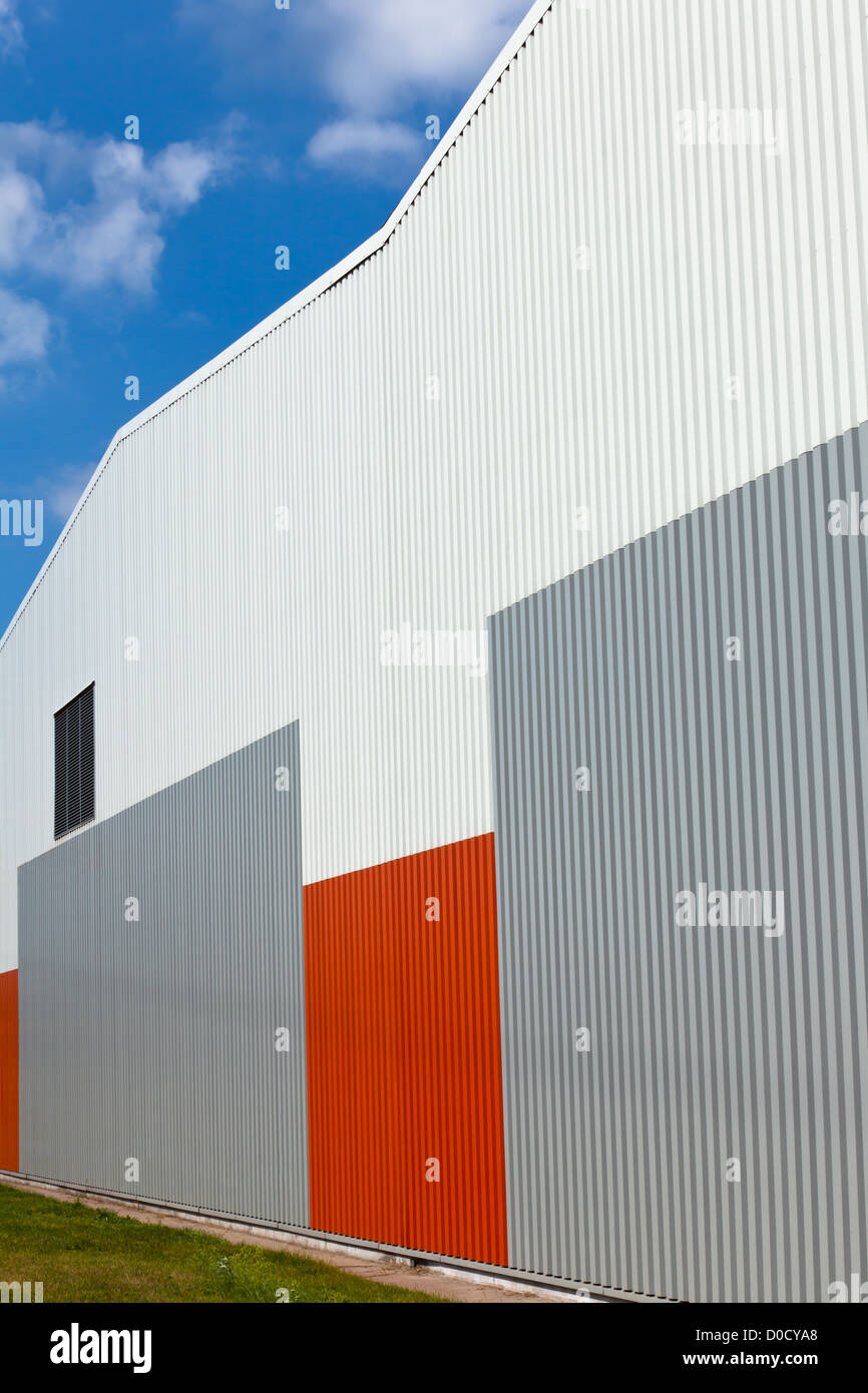 Brightly colored industrial warehouse exterior wall. Vertical shot