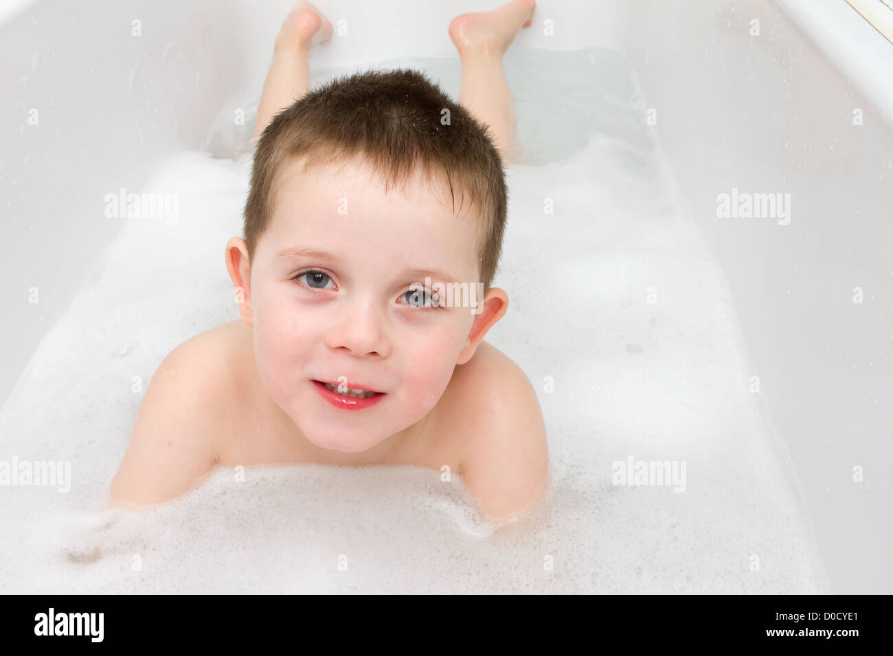 Little Boy in the bath tub with bubbles Stock Photo - Alamy