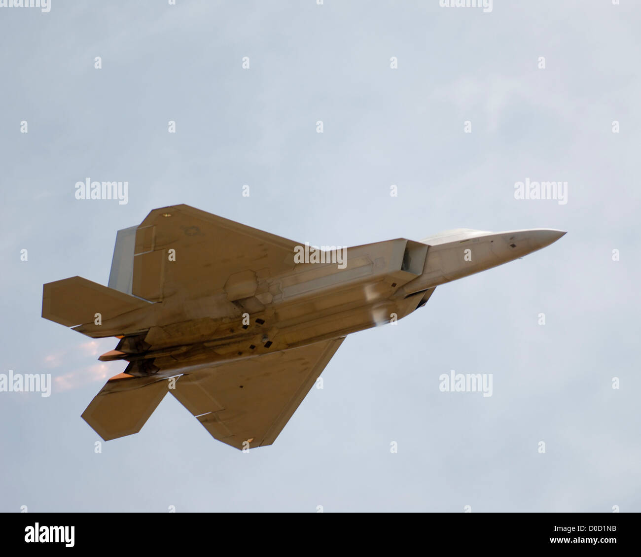 US Air Force F-22 Raptor Roars Through The Sky Under Full Afterburner Stock Photo