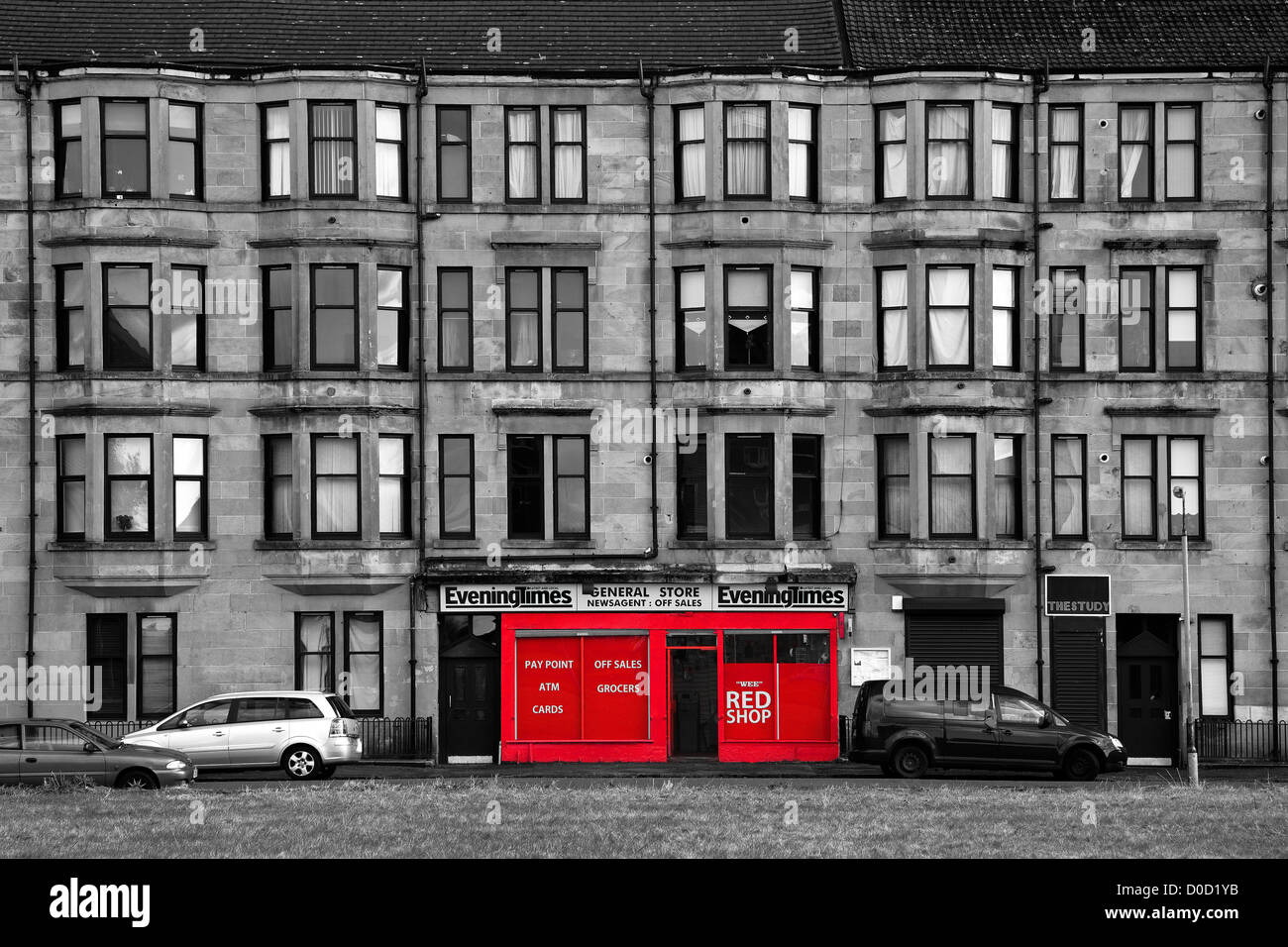 Traditional sandstone tenement building with a red fronted shop, Govan, Glasgow, Scotland. UK Stock Photo