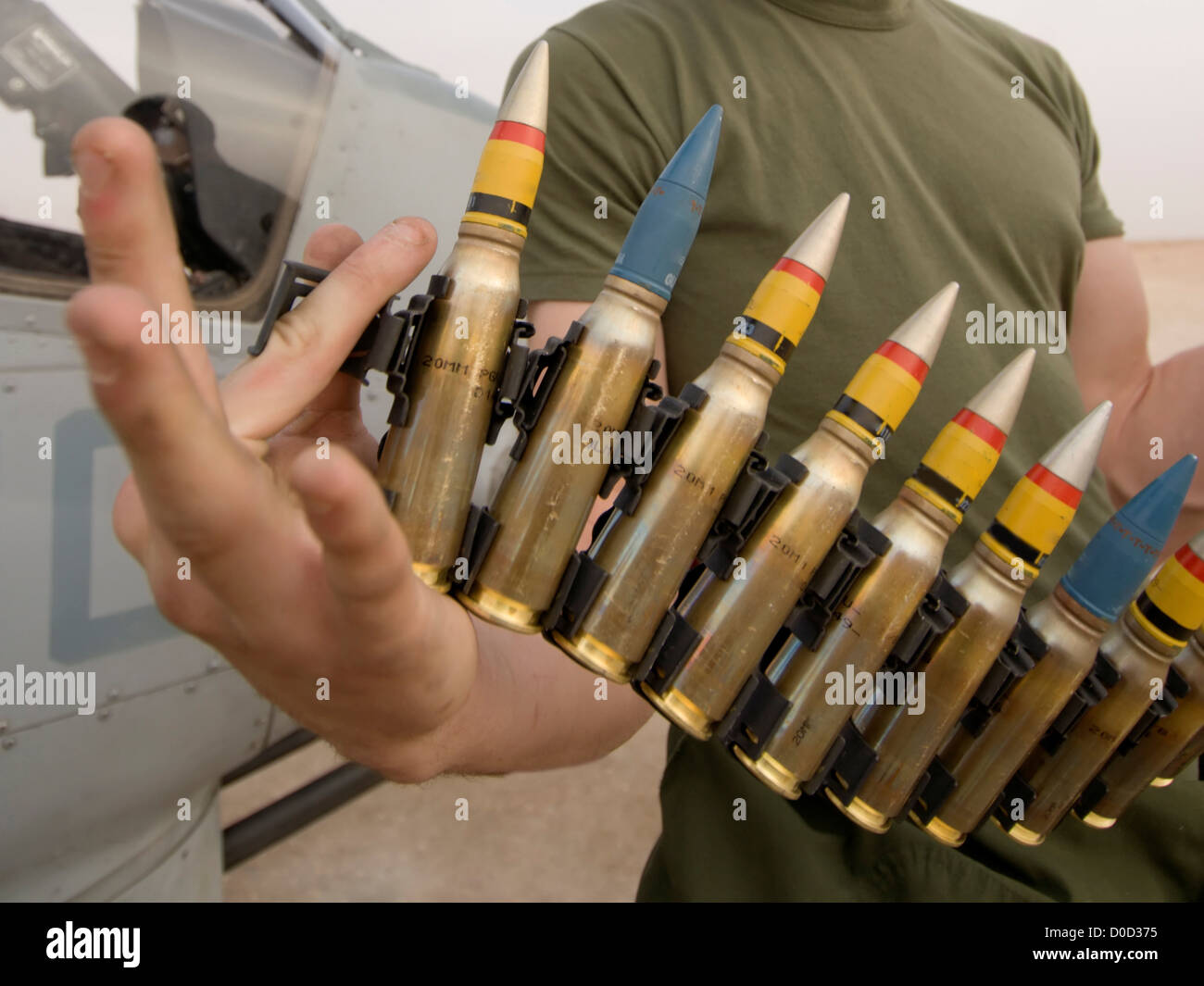 A US Marine Corps Weapons Technician Shows Off 20mm High Explosive Rounds be Loaded onto AH-1W Super Cobra Attack Helicopter Al Stock Photo