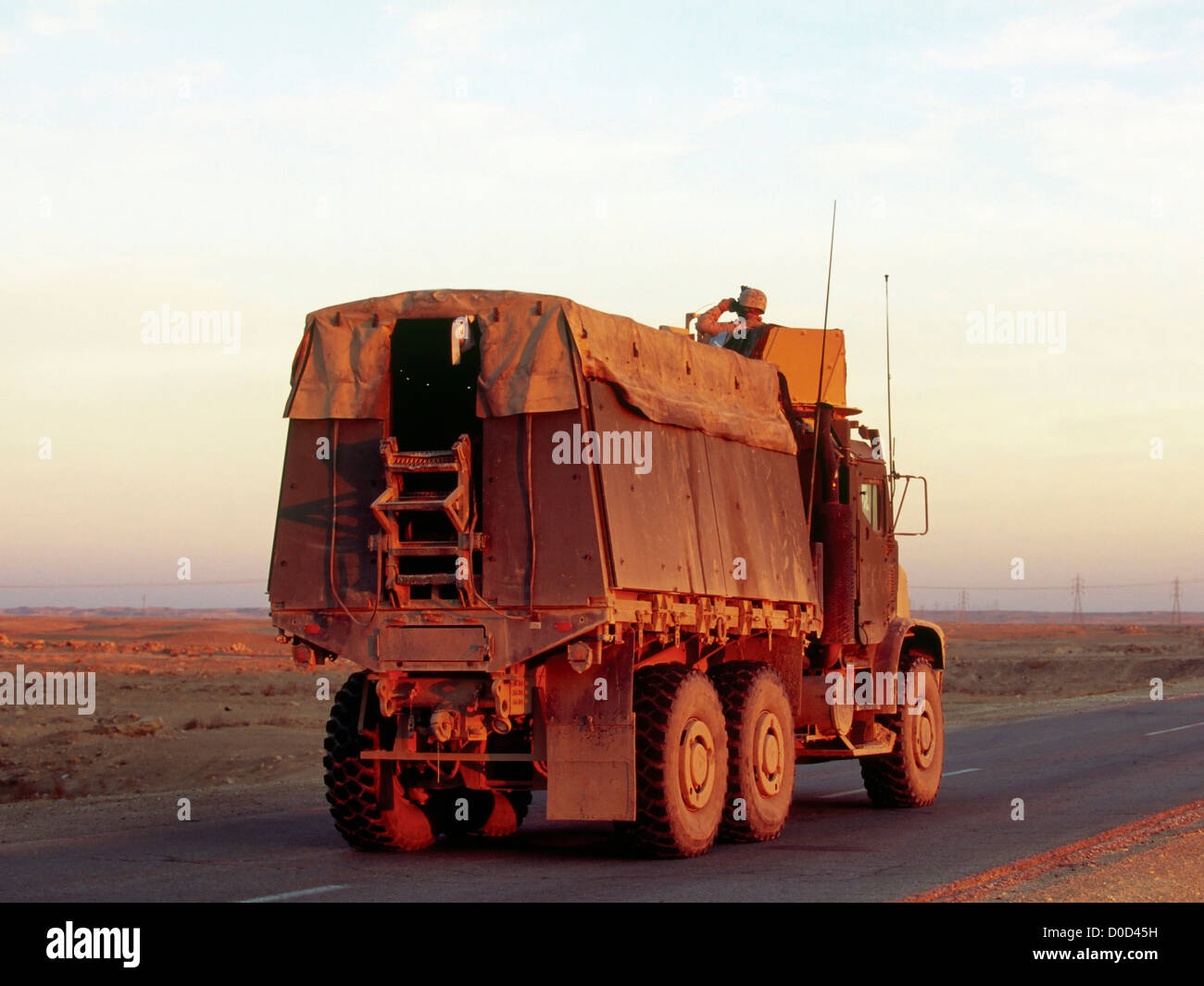 A US Marine 7 Ton Transport Slowly Drives Along a Road in Iraq's Anbar Province During a Sweep for Hidden Explosives Stock Photo