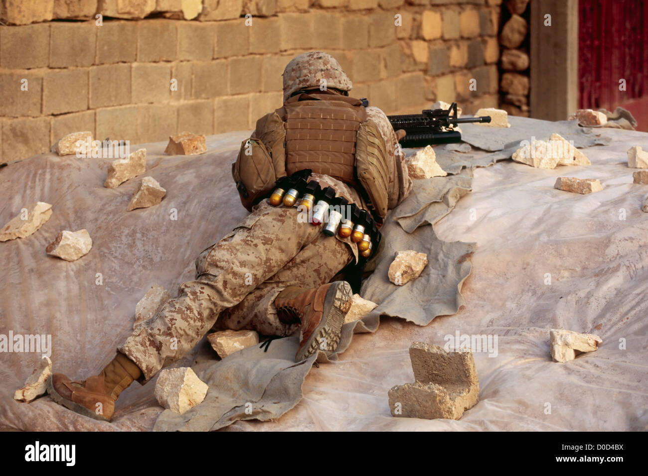 A US Marine Takes Cover During a Combat Operation in the City of Haditha, Iraq Stock Photo