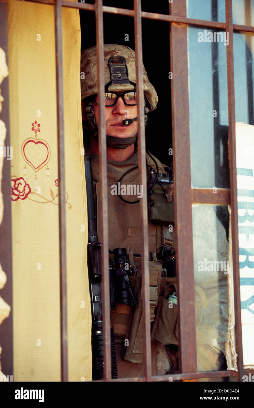 A US Marine Scans Nearby Buildings for Hidden Weapons, Haditha, Iraq Stock Photo