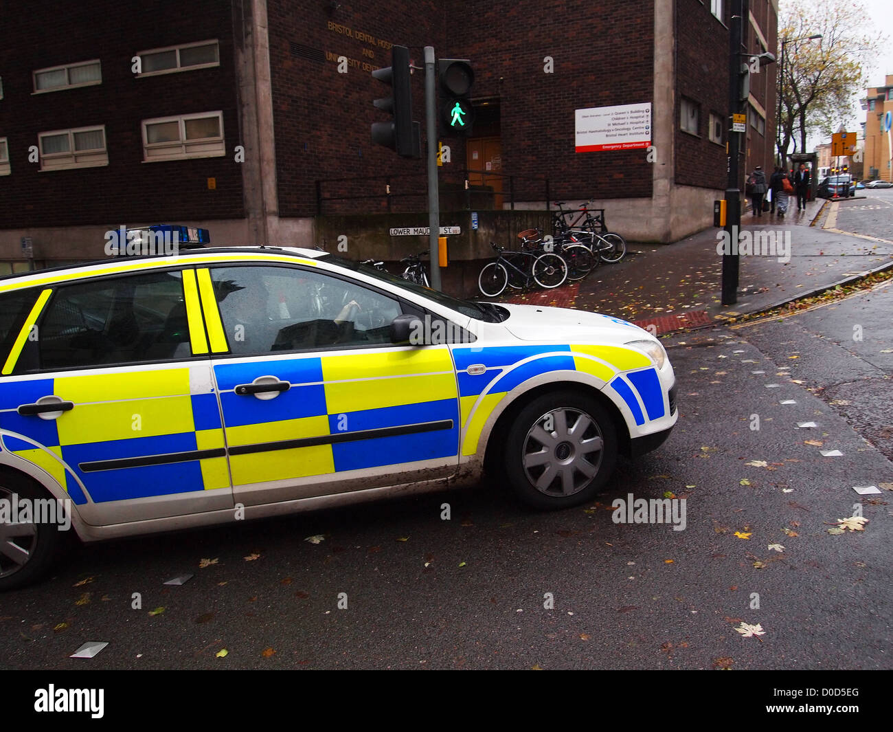 Police car on a blue light run exiting Lower Maudlin Street, near the BRI in Bristol, England, UK, November 2012 Stock Photo