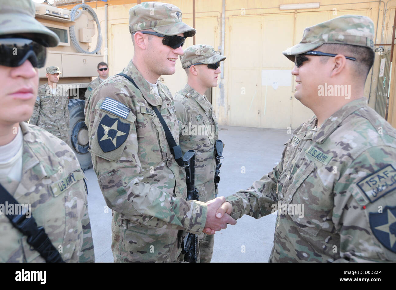 U.S. Army Spc. Spc. Chase Moore, a security force team member for Provincial Reconstruction Team (PRT) Farah shakes hands with C Stock Photo