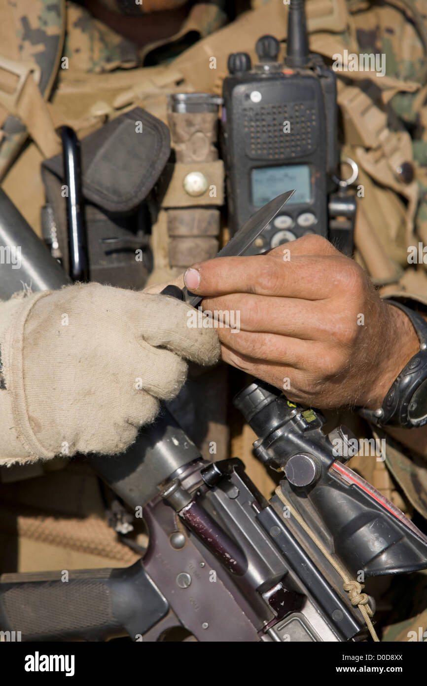 U.S. Marine Holding his M16 Service Rifle, Knife, and Radio Stock Photo