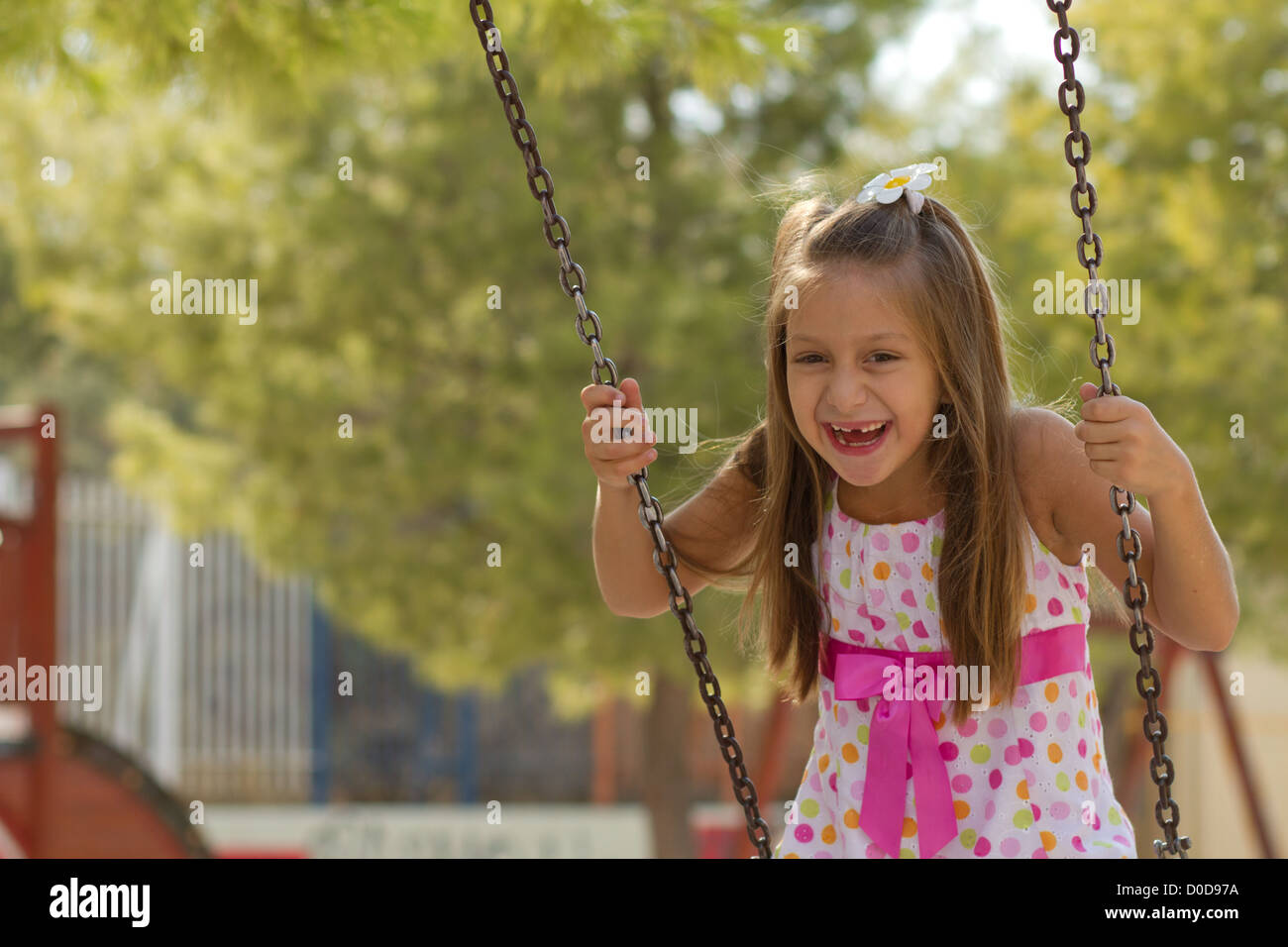 Cute little girl posing on the playgorund at bright summer day Stock ...