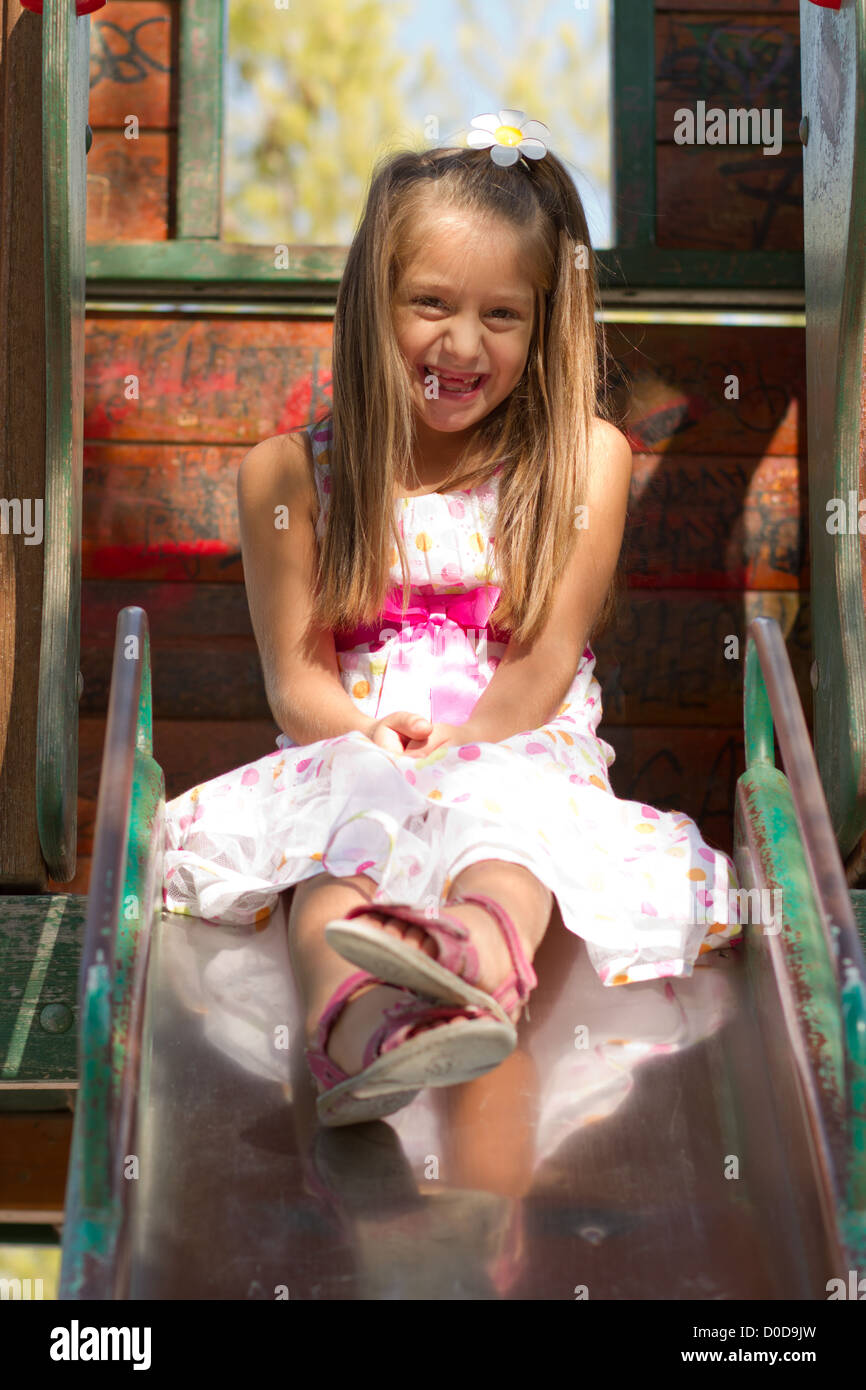 Cute little girl posing on the playgorund at bright summer day Stock ...