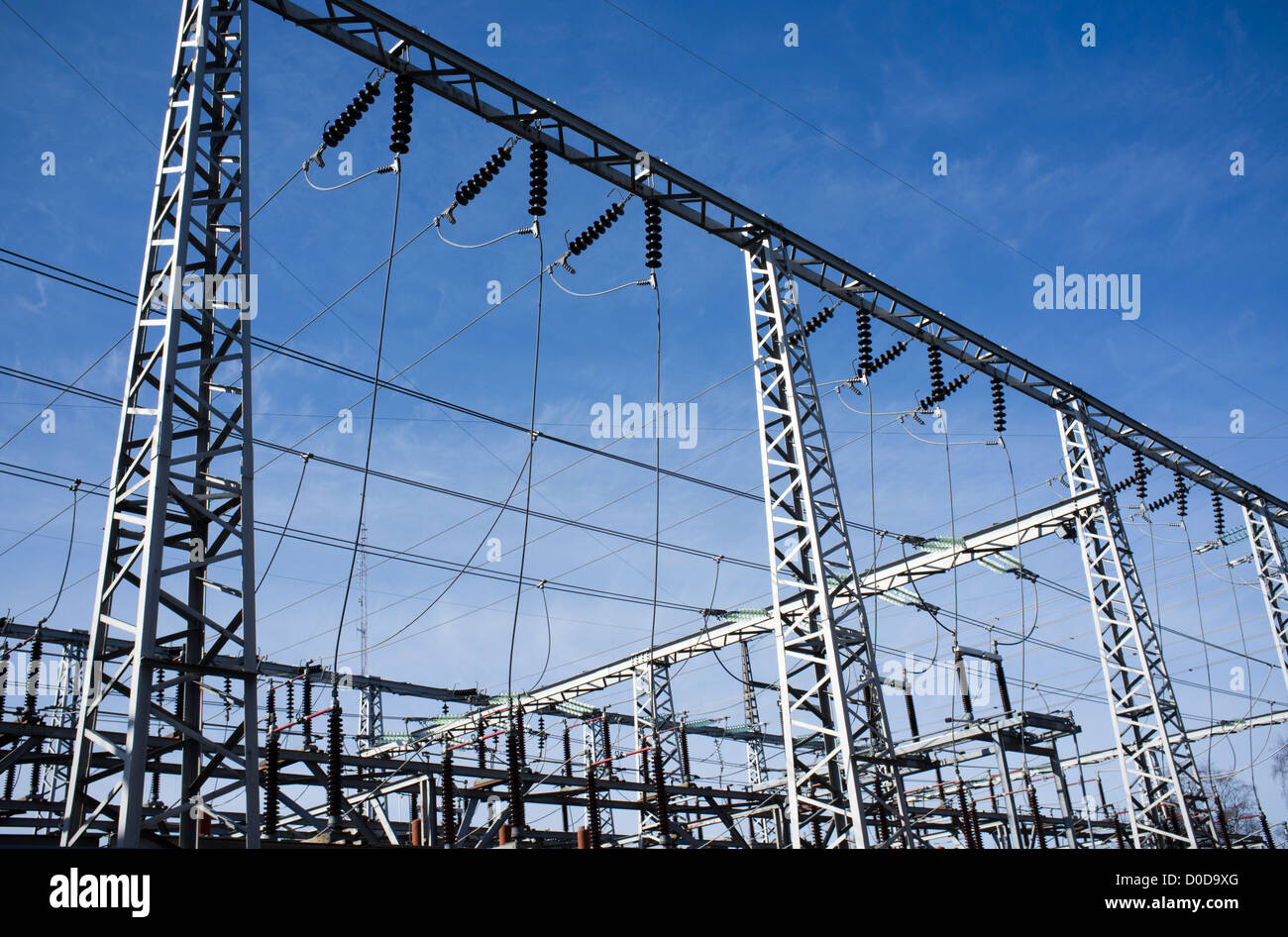 High-voltage overhead power transmission lines against blue sky , Finland Stock Photo