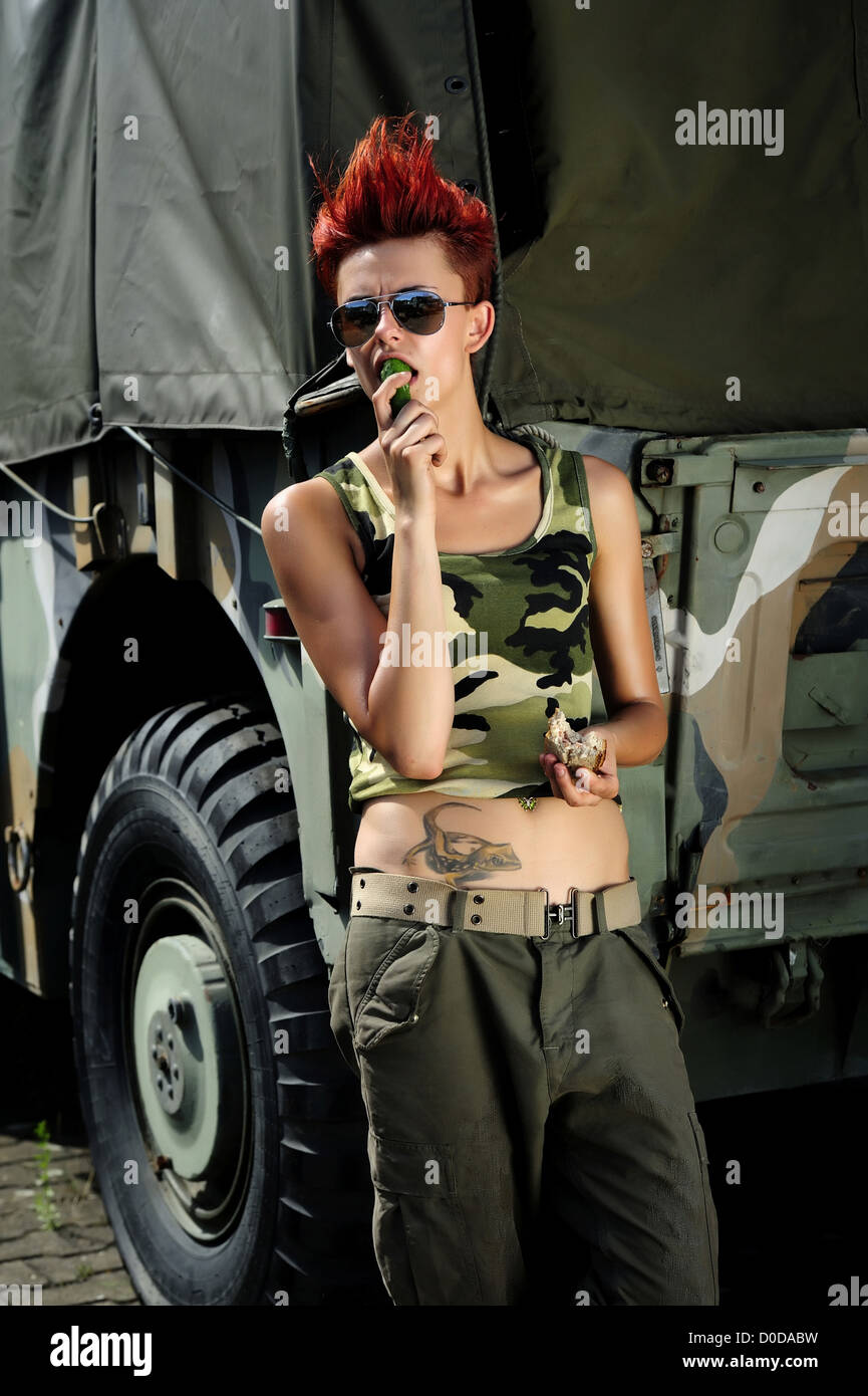 a young girl wearing a army style outfit, army, girl, military, outdoor, people, women Stock Photo