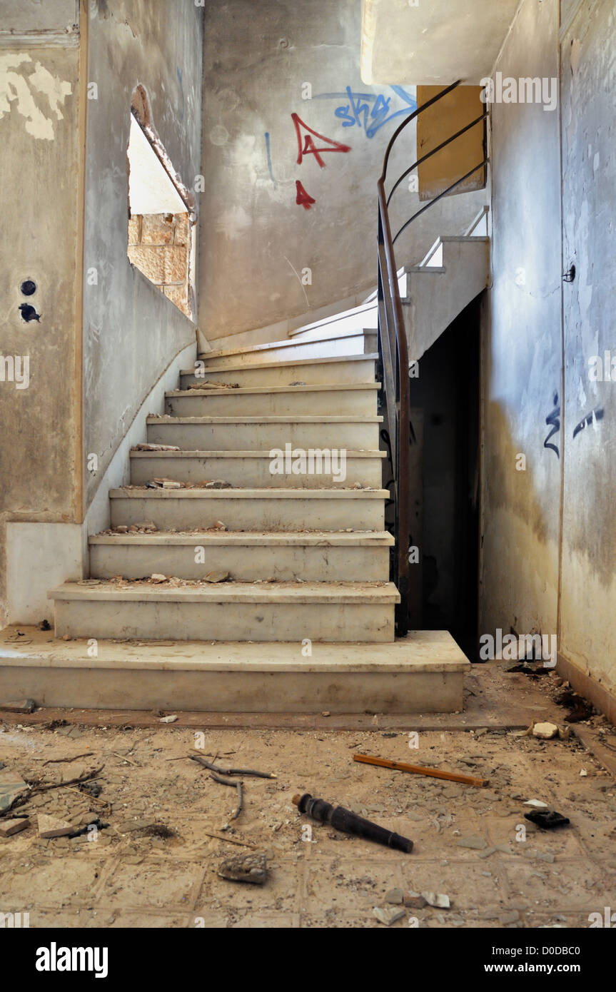 Vintage staircase and dirty floor in abandoned building interior. Stock Photo
