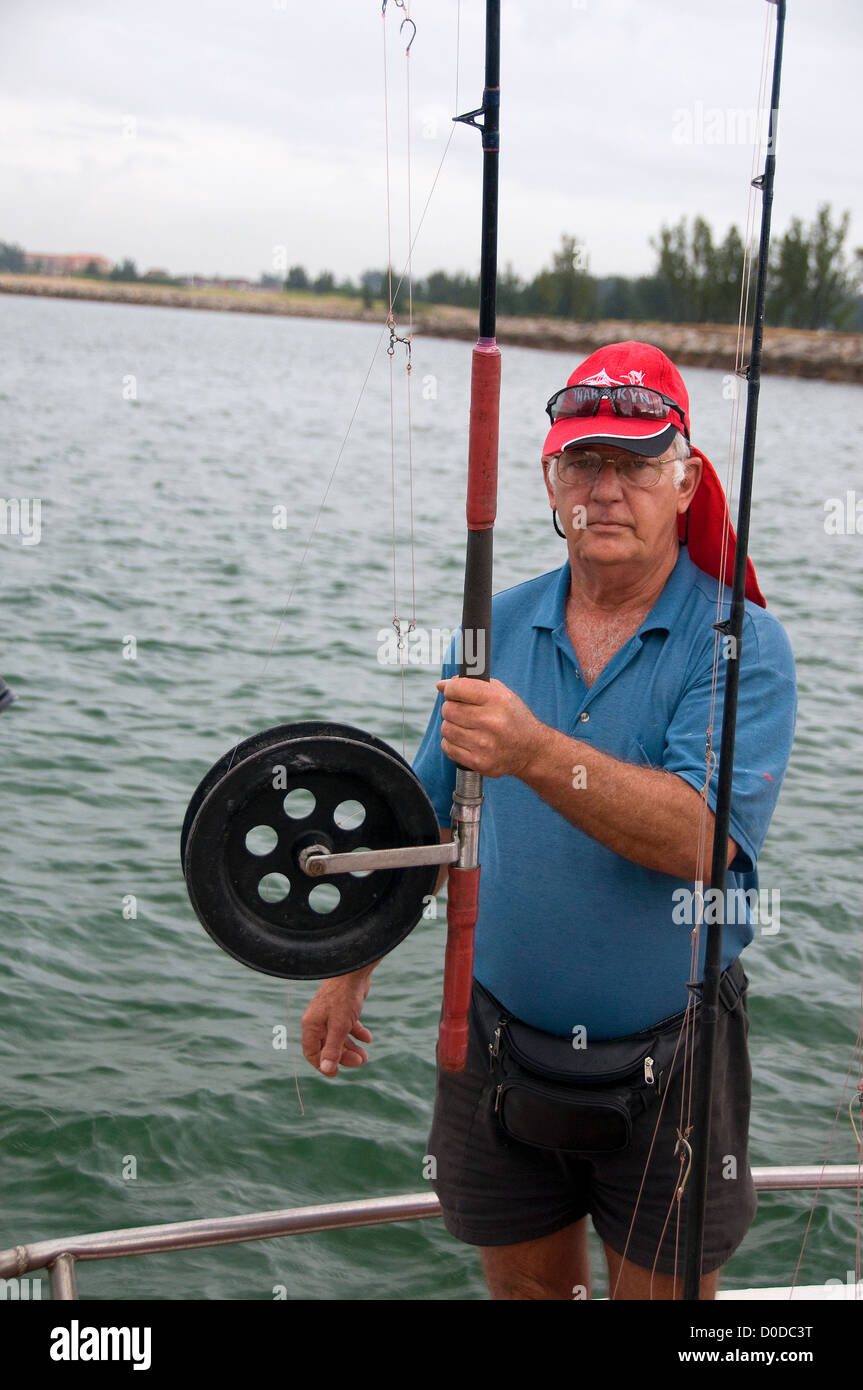 A charter boat captain shows off an extra large trolling reel for saltwater  fish at Richard's Bay, KwaZulu Natal, South Africa Stock Photo - Alamy