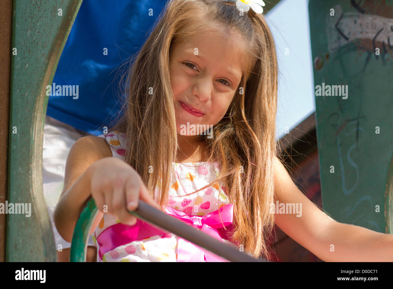 Cute little girl posing on the playgorund at bright summer day Stock ...