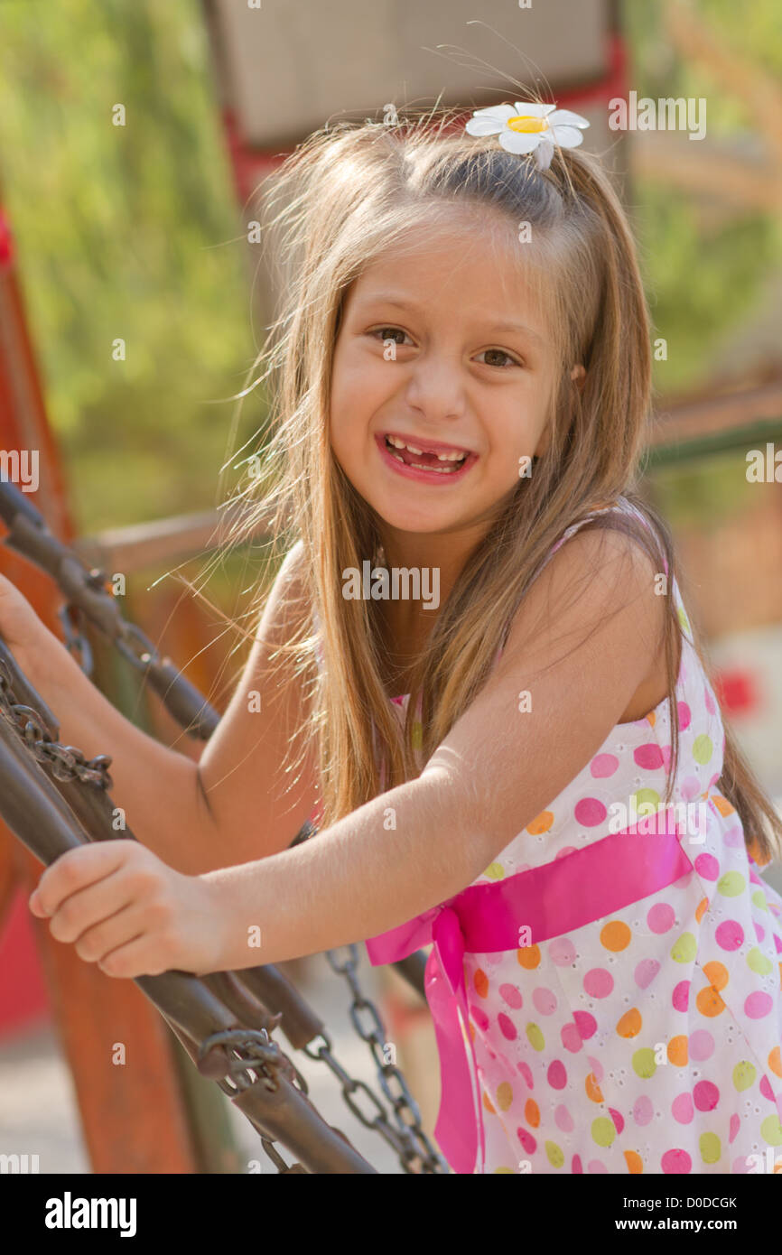 Cute little girl posing on the playgorund at bright summer day Stock ...