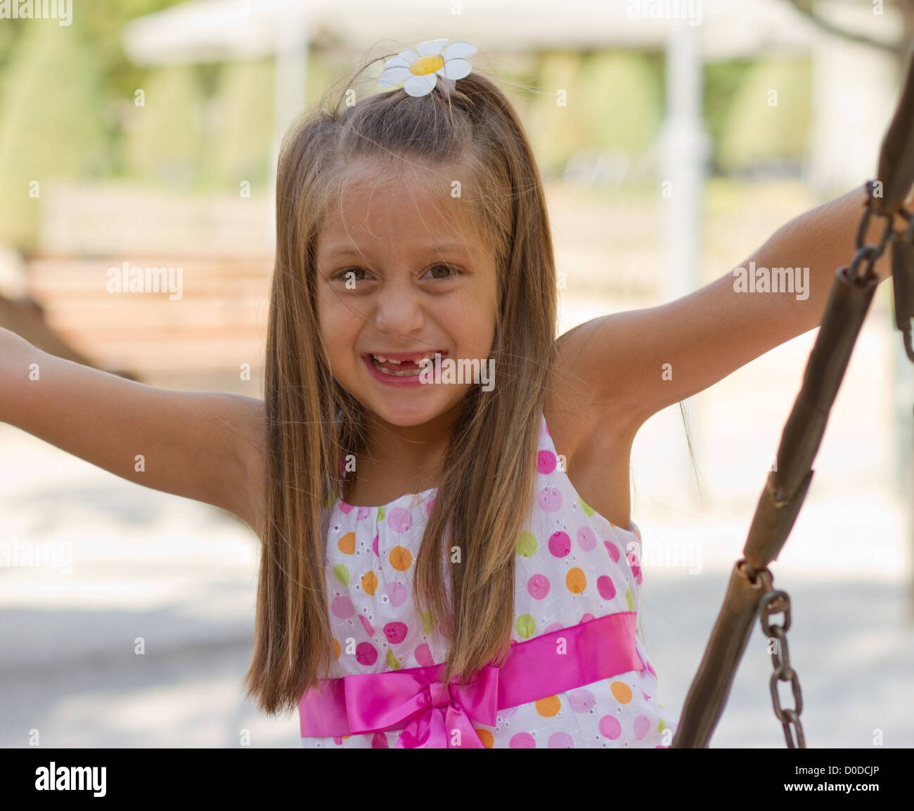 Cute little girl posing on the playgorund at bright summer day Stock ...