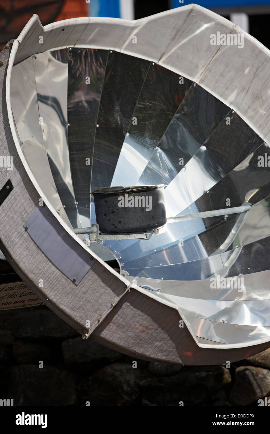 A parabolic solar water heater heats a bowl of water at Lukla, Nepal, in the Mount Everest region. Stock Photo
