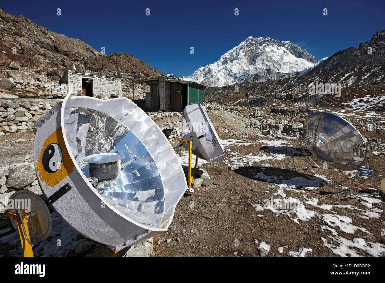 A parabolic solar water heater heats a bowl of water at Lobuche, Nepal, in the Mount Everest region. Stock Photo