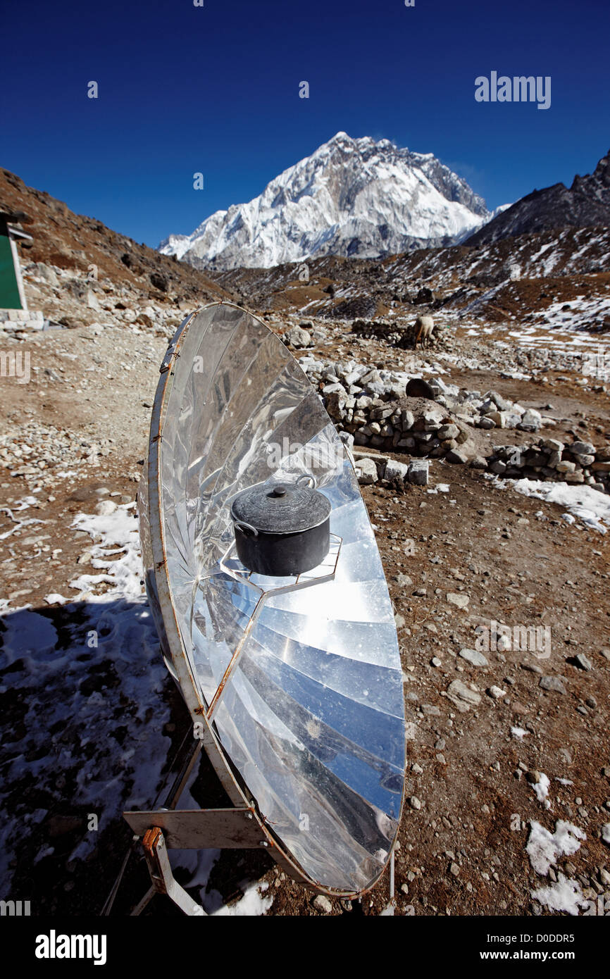 A parabolic solar water heater heats a bowl of water at Lobuche, Nepal, in the Mount Everest region. Stock Photo