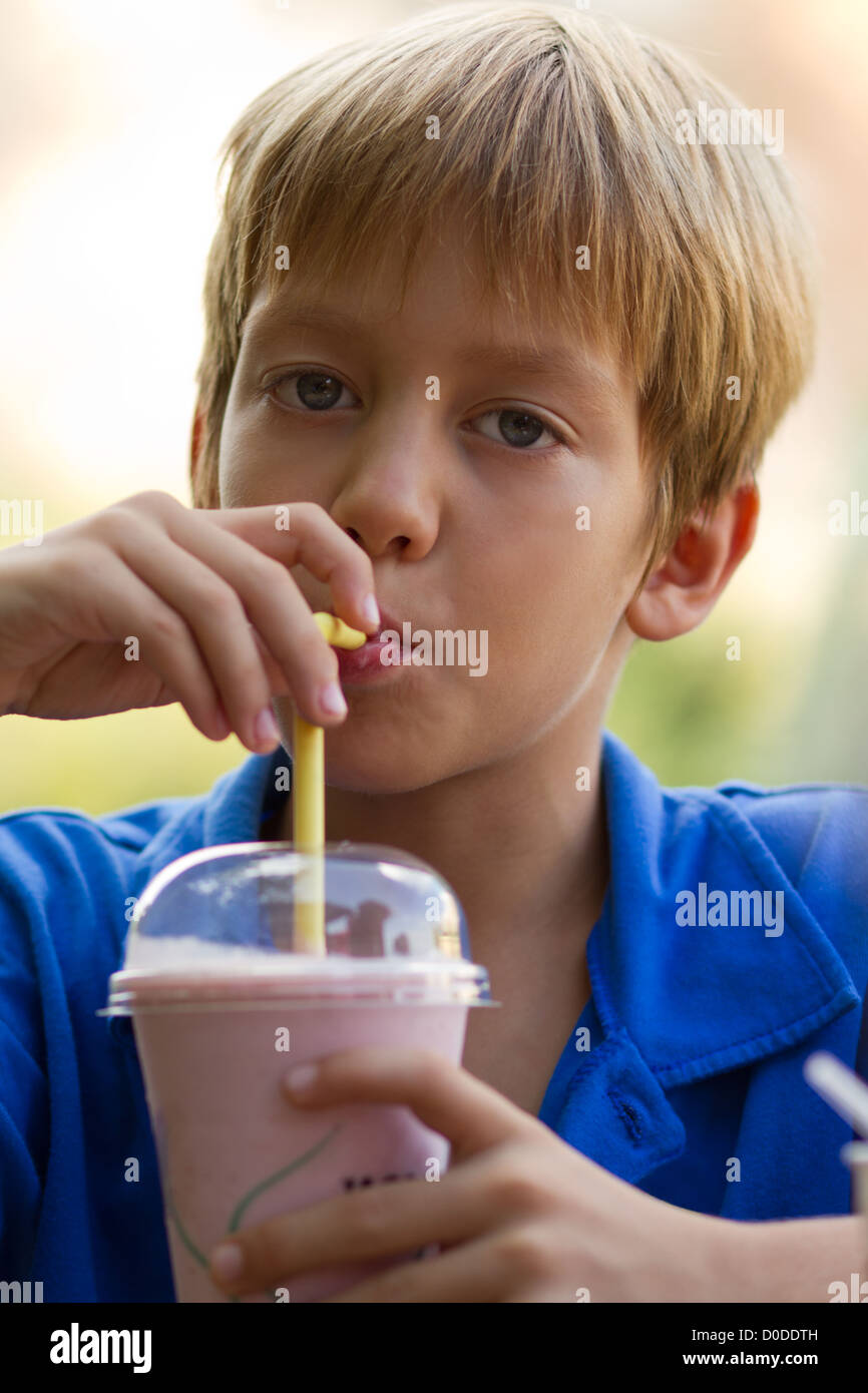 Little brother and sister drinking milkshakes in a cafe outdoors Stock ...