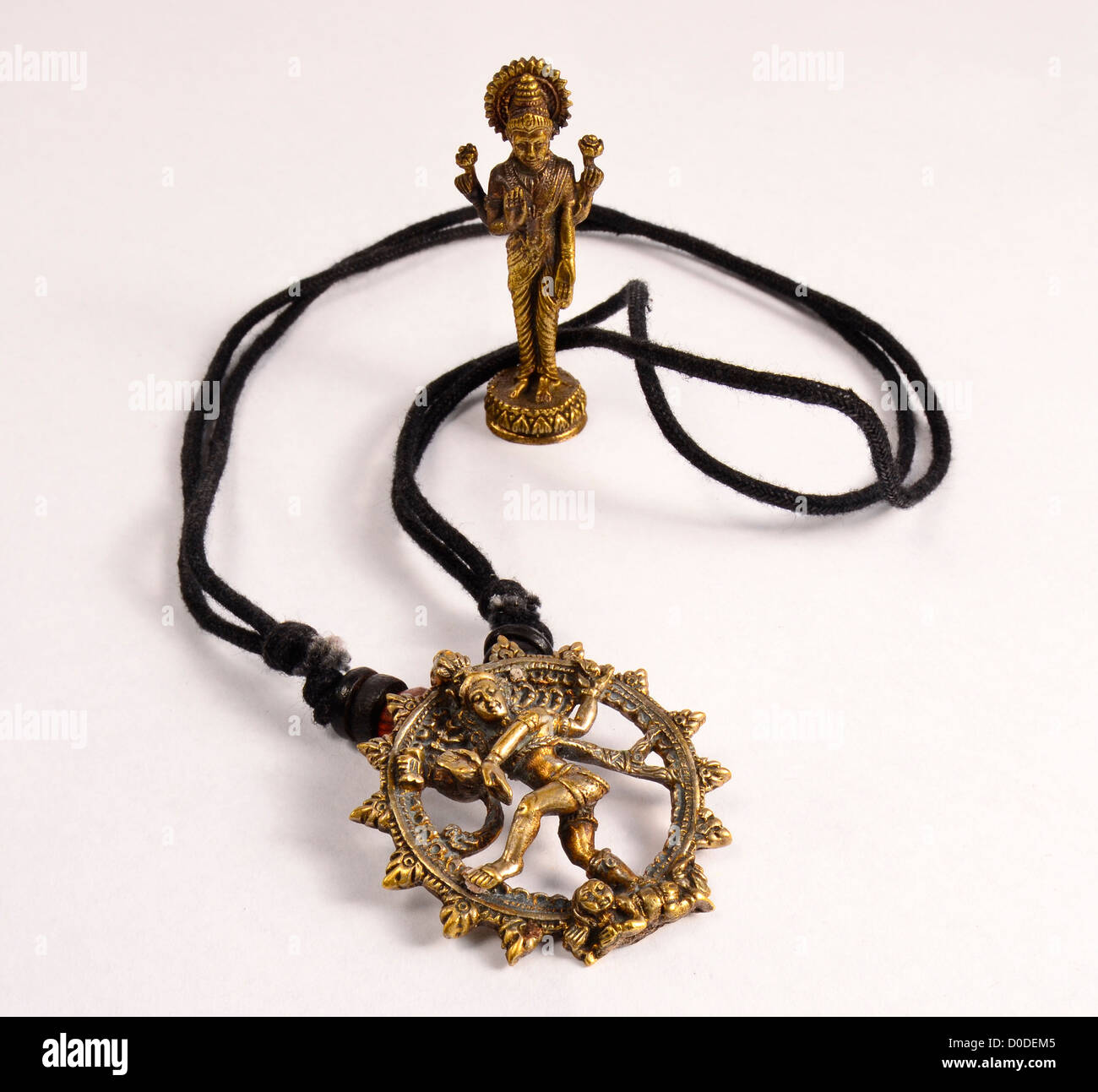 Hindu God Pendant on string necklace and figurine Stock Photo Alamy