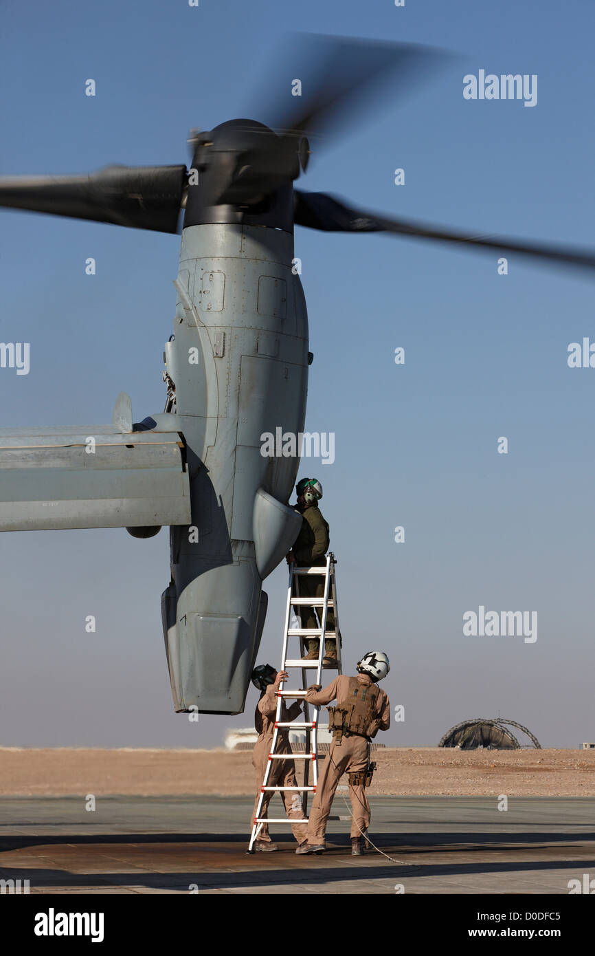 U.S. Marine Corps aircraft maintainers work on engine MV-22 Osprey Camp Bastion Helmand Province Southern Afghanistan. Stock Photo