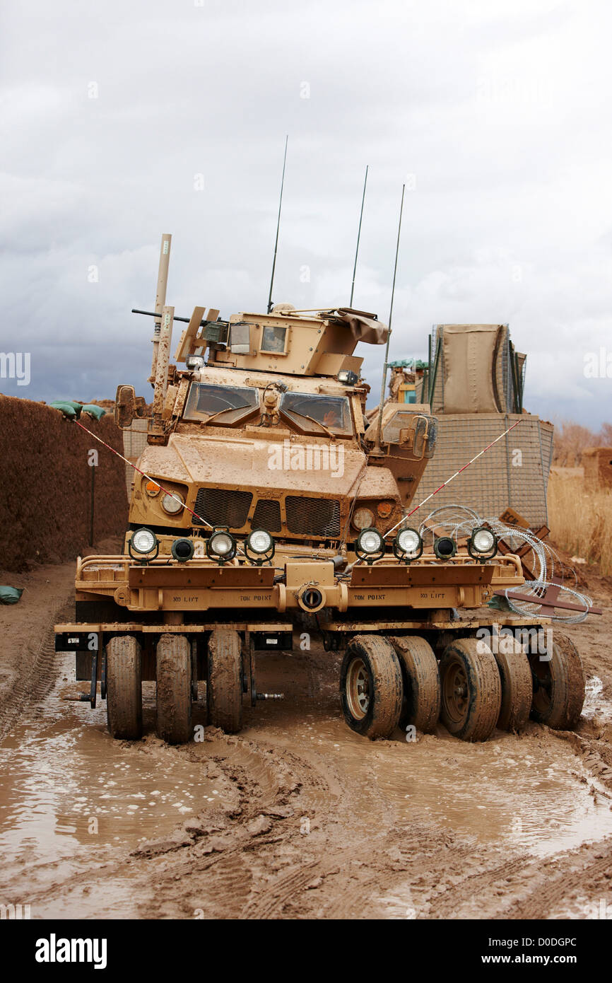 M-ATV or Mine Resistant Ambush Protected All Terrain Vehicle mine roller  fitted it drives through puddles on muddy dirt road in Stock Photo - Alamy