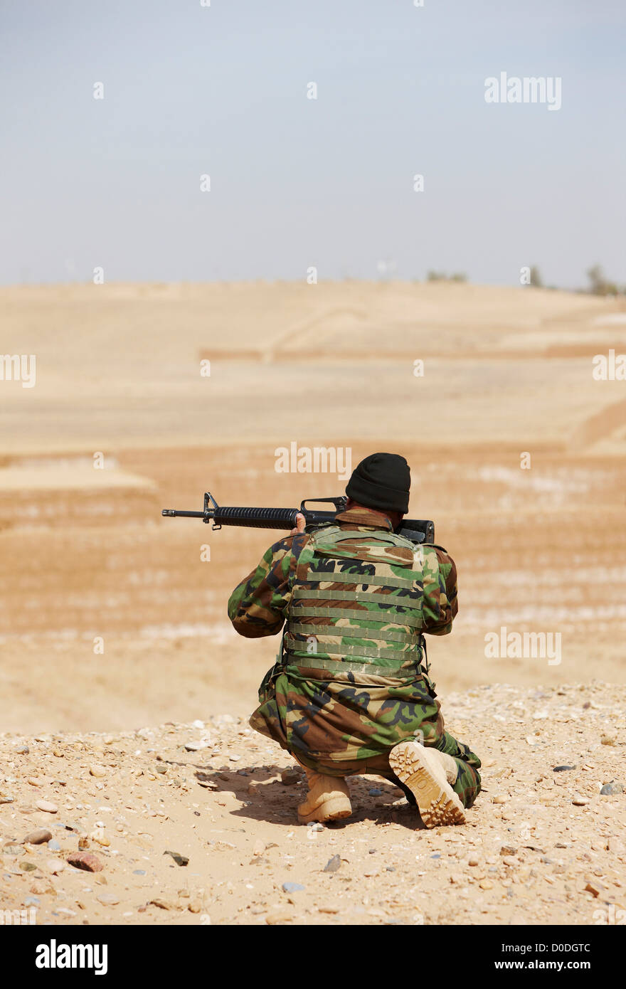 Afghan National Army soldier aims an M16 rifle during a combat operation in Afghanistan's Helmand Province Stock Photo