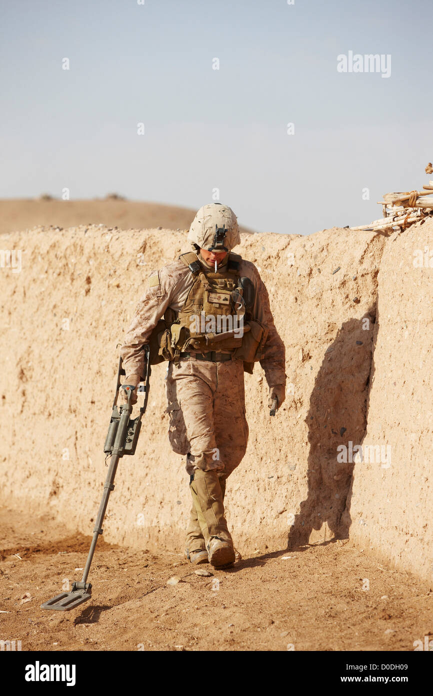 United States Marine combat engineer uses metal detector sweep hidden