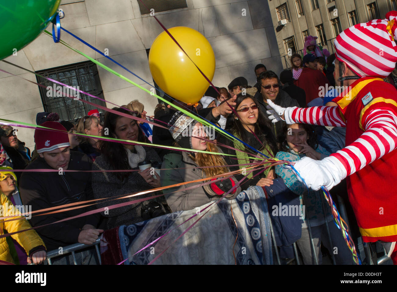 Clown hands out balloons along Central Park West at Macy's Thanksgiving Day Parade in New York City, on Thursday, Nov. 22, 2012. Stock Photo