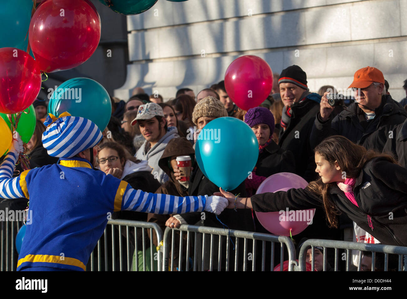 Clown handing out balloons to spectators at Macy's Thanksgiving Day Parade in New York City, on Thursday, Nov. 22, 2012. Stock Photo