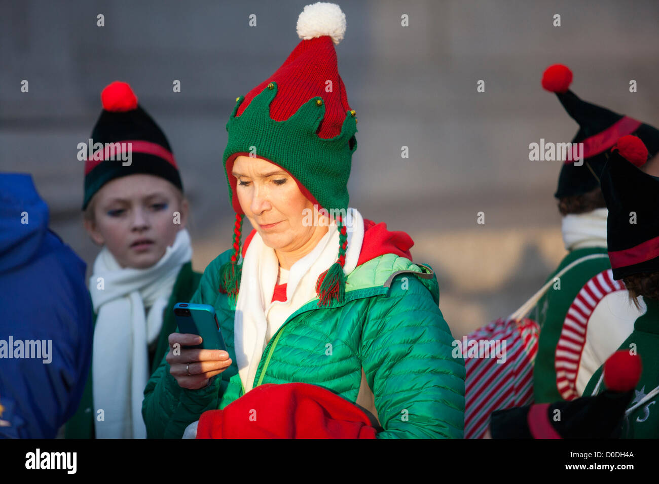 A costumed character checks her cell phone while waiting for the start of Macy's Thanksgiving day parade in New York City, on Thursday, Nov. 22, 2012. Stock Photo